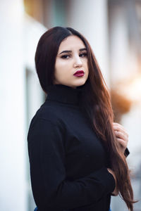 Portrait of a beautiful young woman standing outdoors