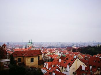 Prague cityscape against foggy sky