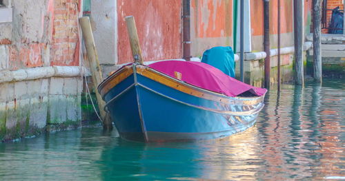 Multi colored boats moored in water