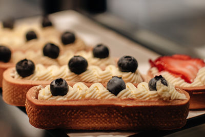 Delicious sweet cake with fresh blueberries and butter cream
