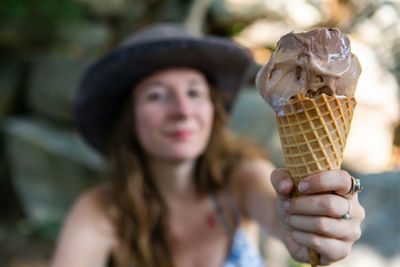 Portrait of woman holding ice cream cone