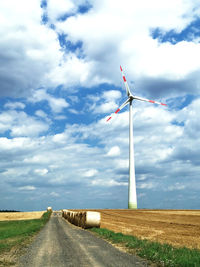 Windmill on field against sky