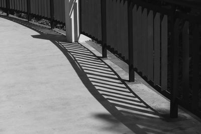 Shadow of railing on footpath