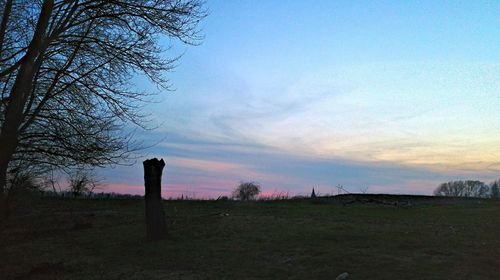 Scenic view of field against cloudy sky