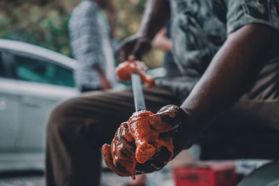 Close-up of hand holding bbq meat