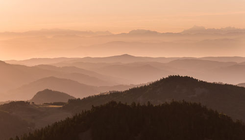 Scenic view of silhouette mountains against sky during sunset