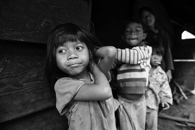 Poor children standing on street