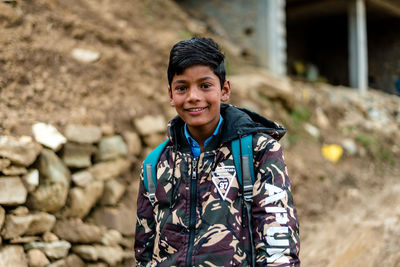 Portrait of smiling young man standing outdoors