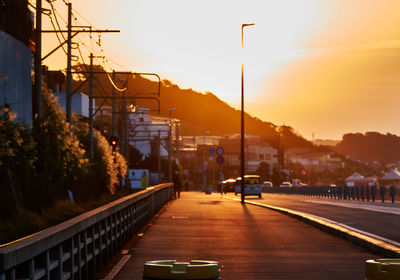 Cars on road in city at sunrise