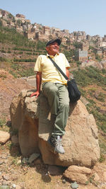 Portrait of young man on rock