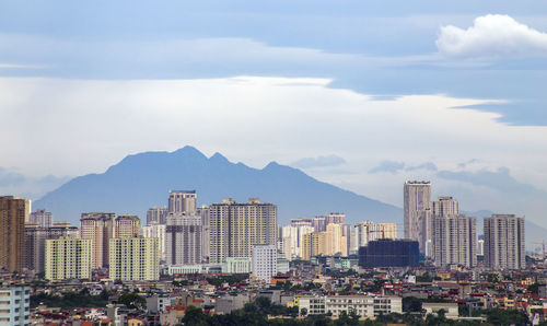 Buildings in city against sky