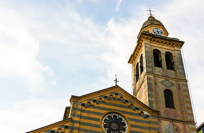 Low angle view of clock tower against sky