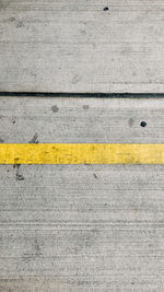 High angle view of yellow lines on road