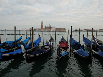 Boats moored in sea against sky