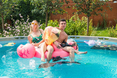 People sitting in swimming pool