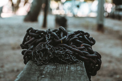 Close-up of metallic chain on wood