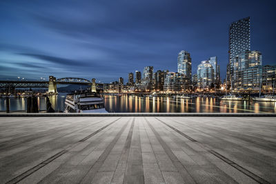 Illuminated city buildings against sky