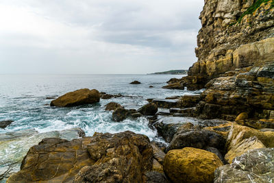 Rocks on beach against sky