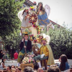 People in traditional clothing standing against trees