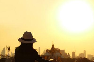 Woman in hat enjoy an amazing view of bangkok skyline with the popular landmarks, thailand