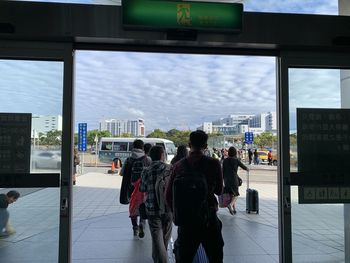 Rear view of people walking on airport