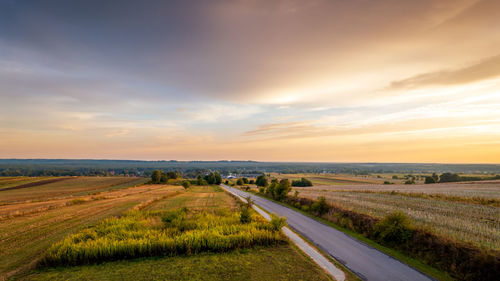 Scenic view of field against sky during sunset