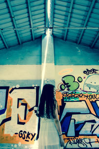 Rear view of man standing in corridor