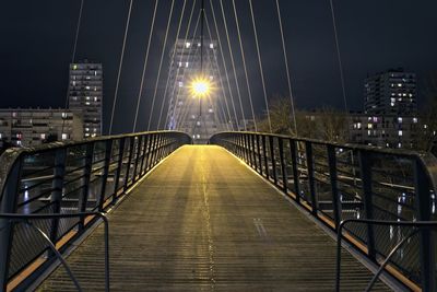 Illuminated suspension bridge at night