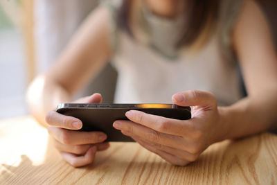 Midsection of woman using mobile phone