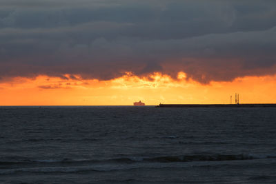 Scenic view of sea against orange sky