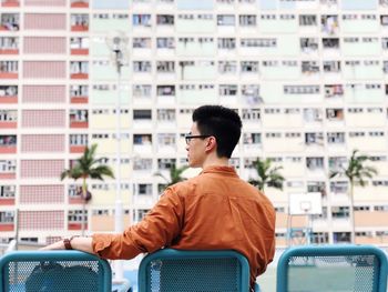 Rear view of man looking away in city