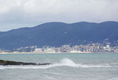 Scenic view of sea and buildings against sky