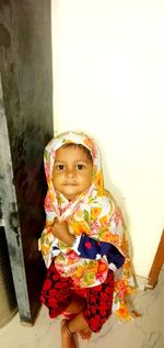 Portrait of smiling girl standing at home