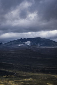 Scenic view of mountain against cloudy sky