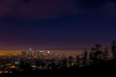 Aerial view of city lit up at night