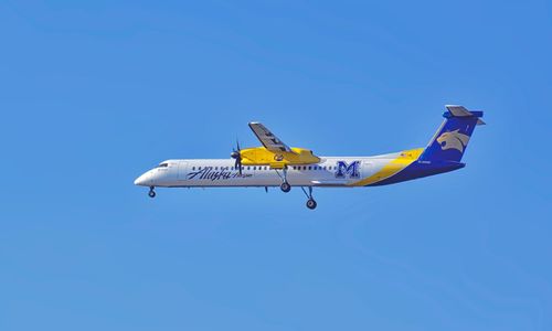 Airplane flying against clear blue sky