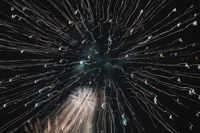 Low angle view of firework display against sky at night