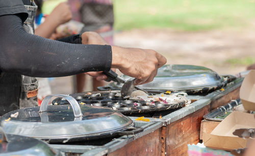 Midsection of man preparing food