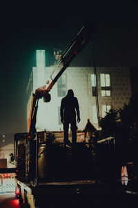 Rear view of silhouette people standing at night