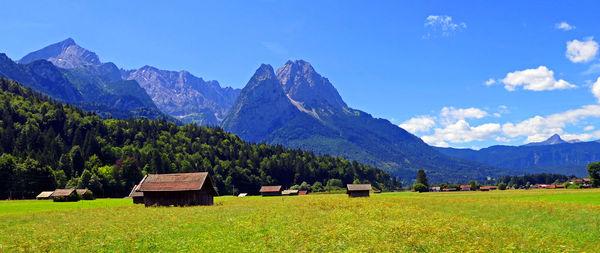 Scenic view of field and mountains against sky