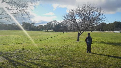 People walking on grassy field