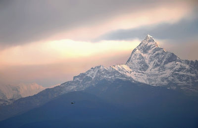 Scenic view of snowcapped mountains against sky during sunset