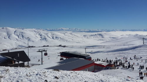 Scenic view of snowcapped mountains against clear blue sky