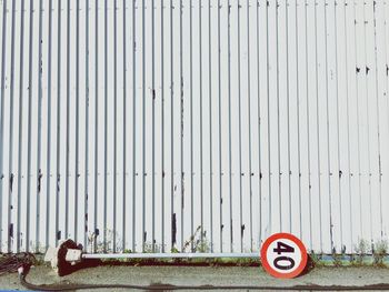 Road sign against wall