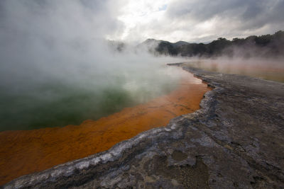 Scenic view of steam emitting from hot spring
