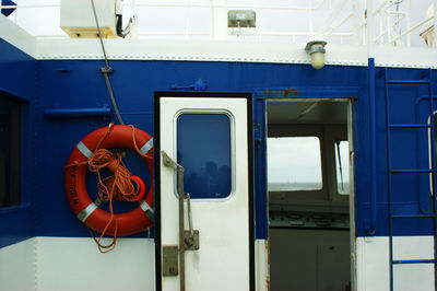 Close-up of life belt on blue boat