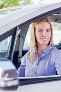 Close-up portrait of woman sitting car