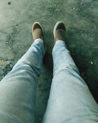 Low section of man standing on beach