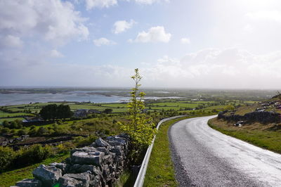 Road by sea against sky