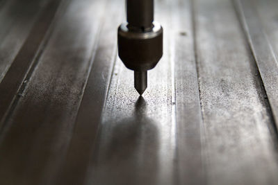 Close-up of drill machine on wood